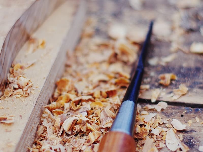Wood carving with golden shavings